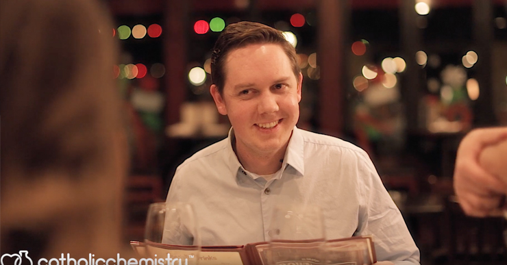 man on date leaning in with smile